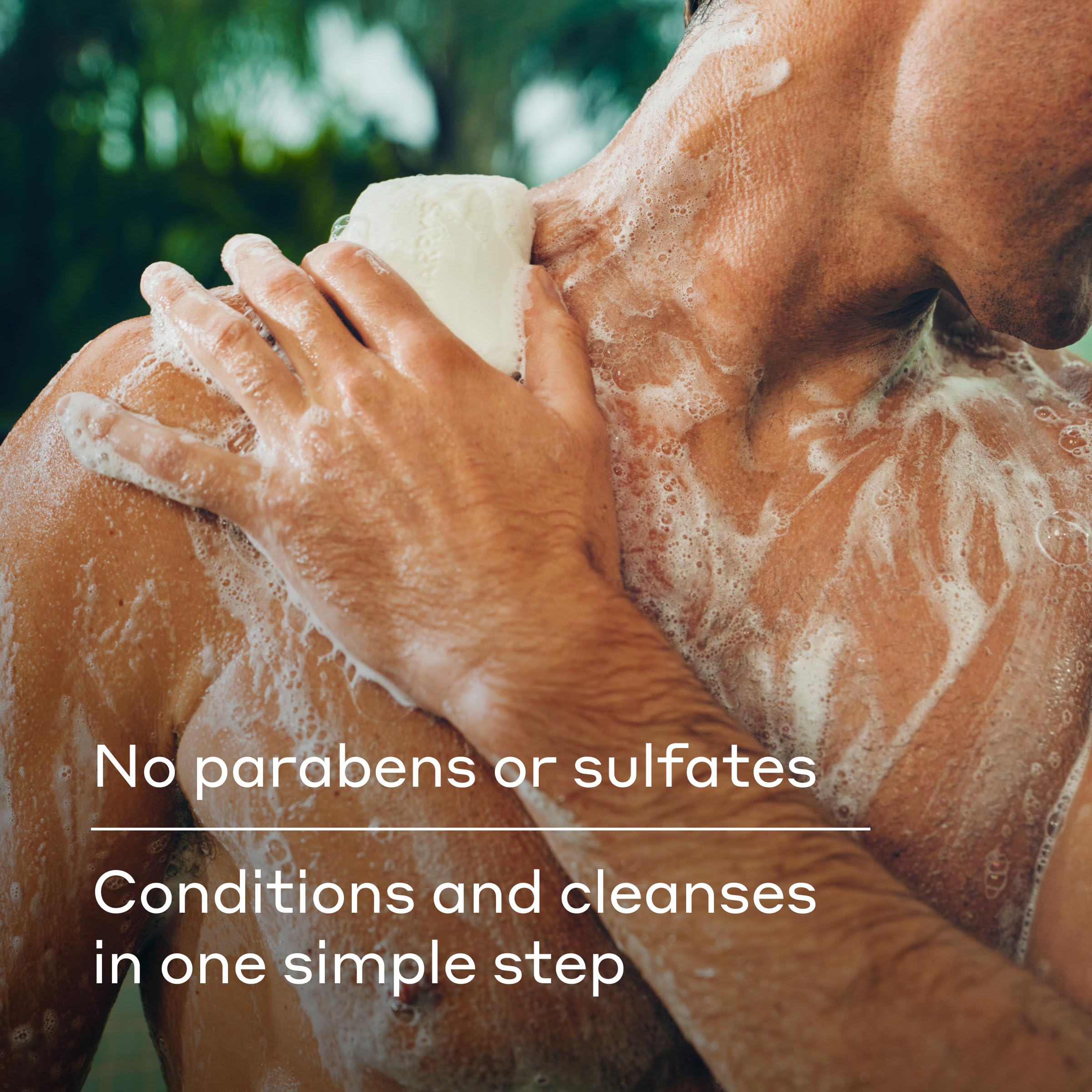Harry's lathered Stone soap in hand demonstrating abundant foam and gentle cleanse