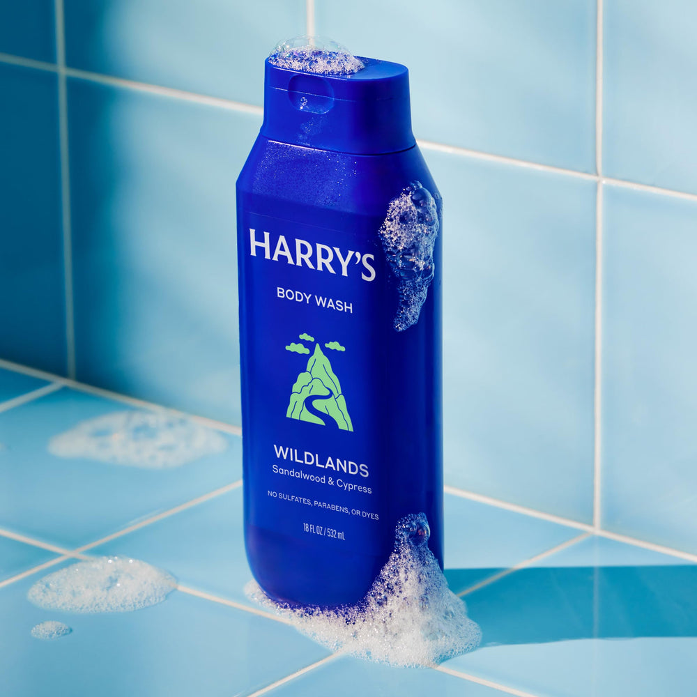 Harry's bottle in hand under shower showing easy dispensing and in-shower use