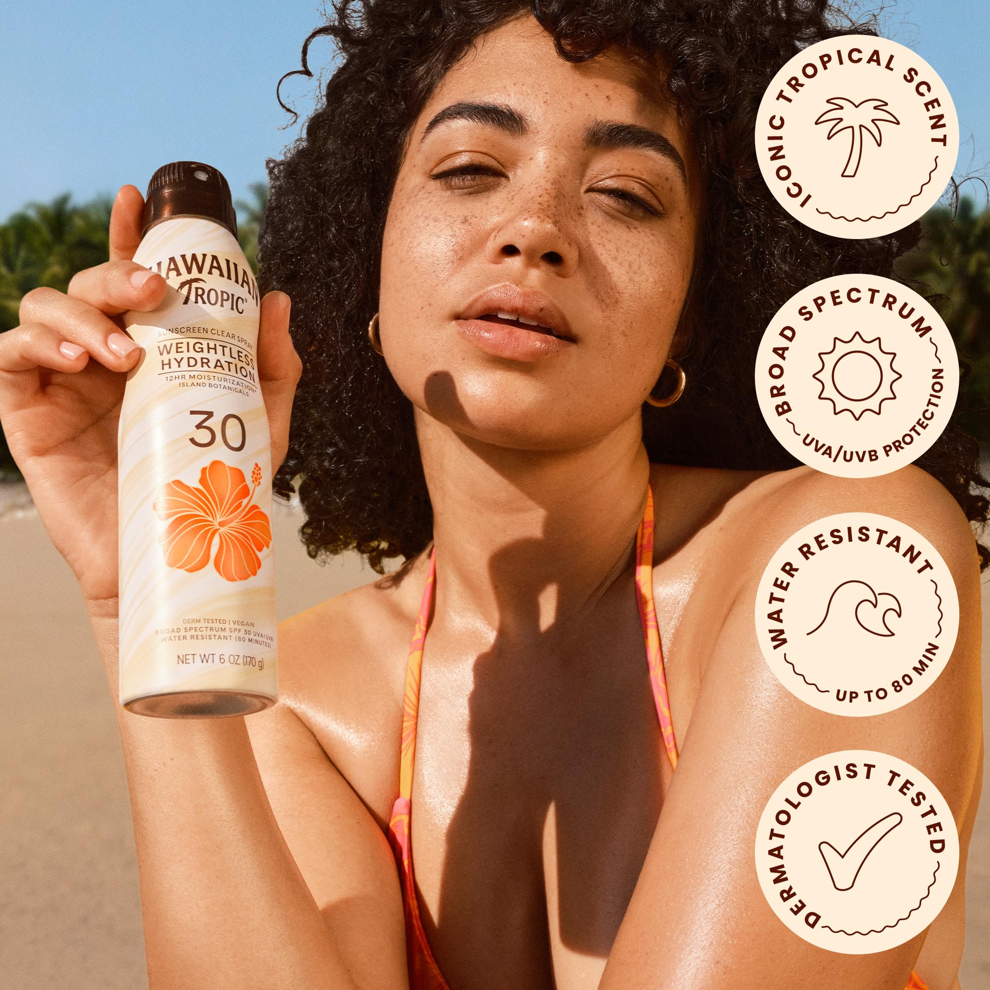 Hawaiian Tropic spray texture on skin showing lightweight, silky finish