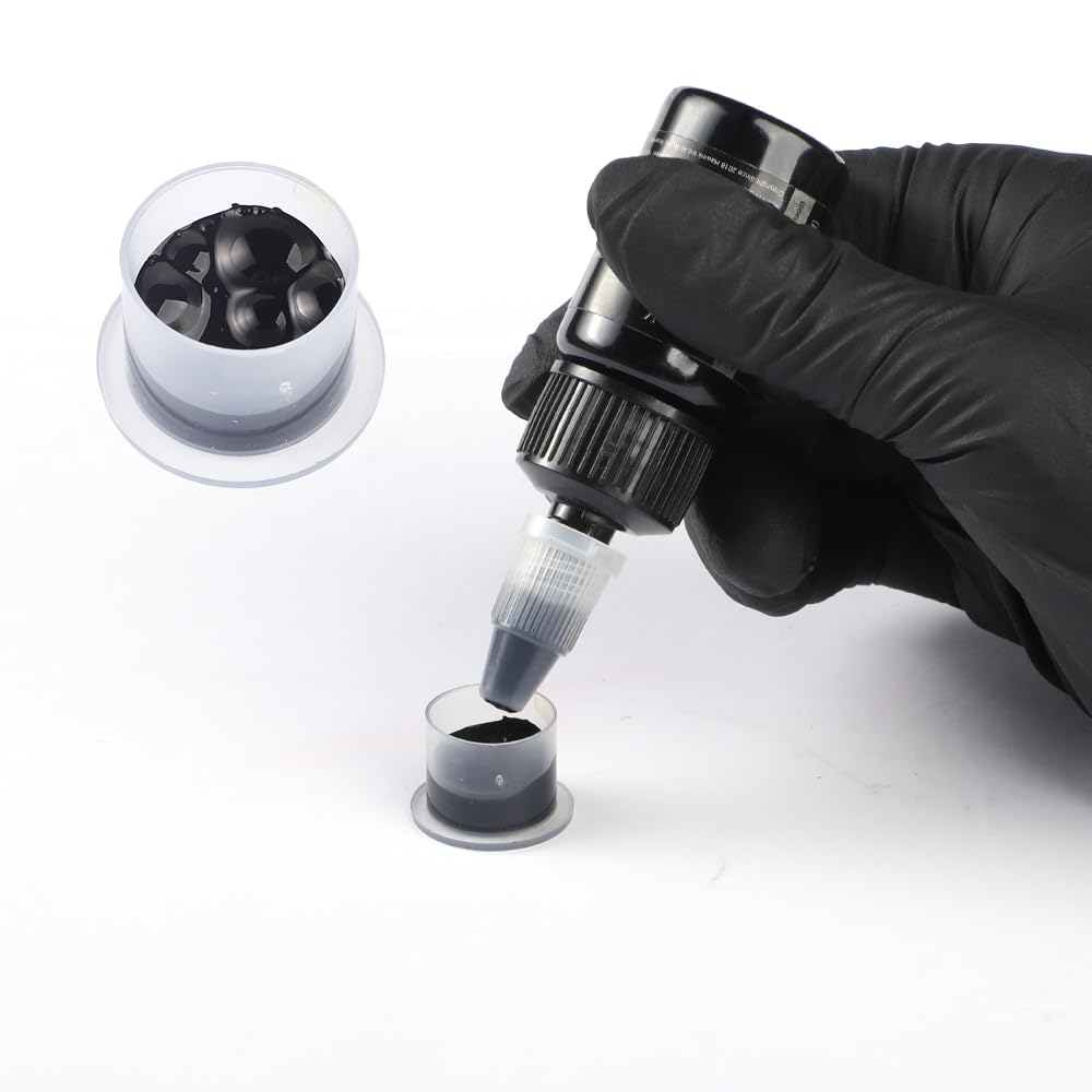 HAWINK ink being dispensed near a tattoo machine illustrating smooth flow control