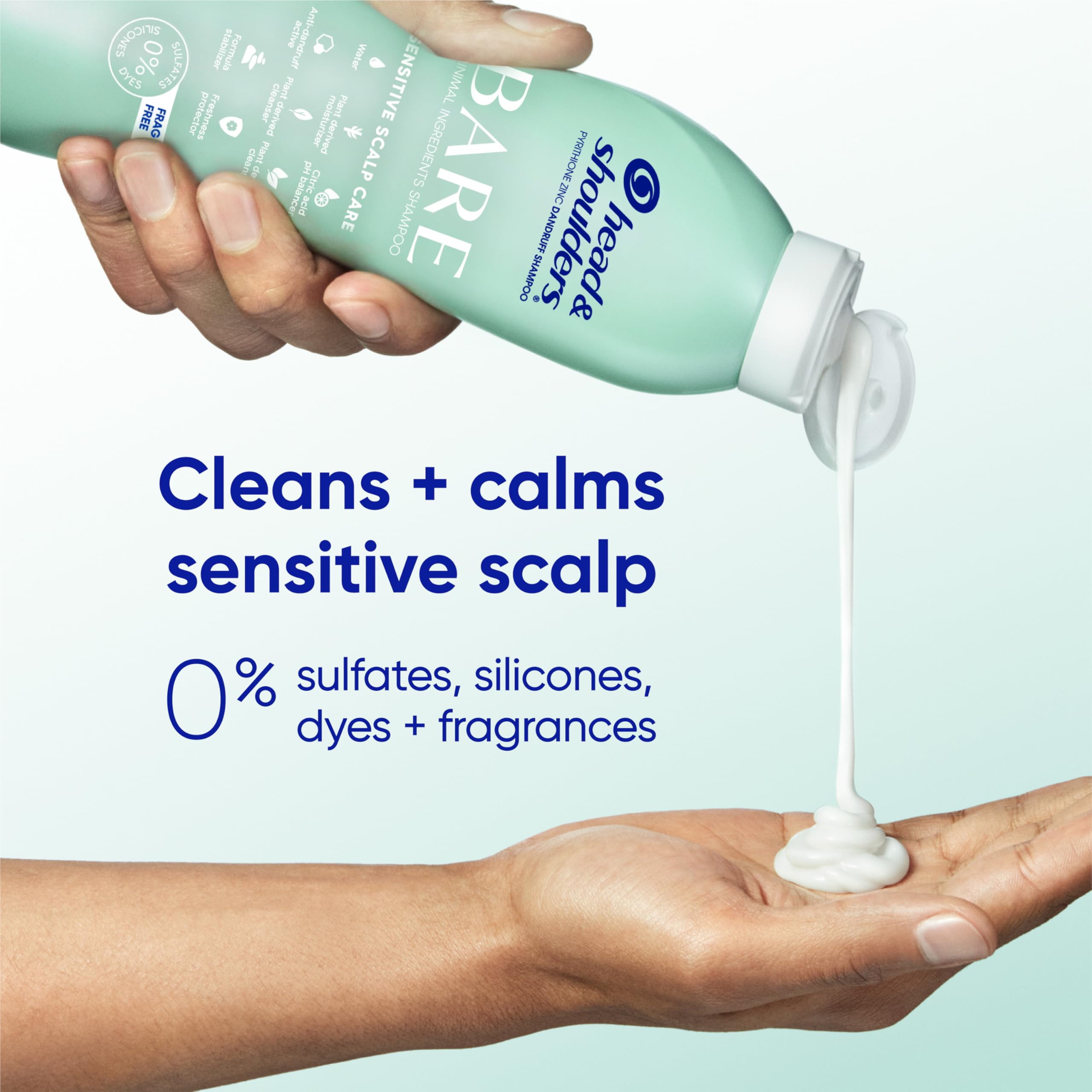 Hand holding bottle beside ruler demonstrating Head & Shoulders size