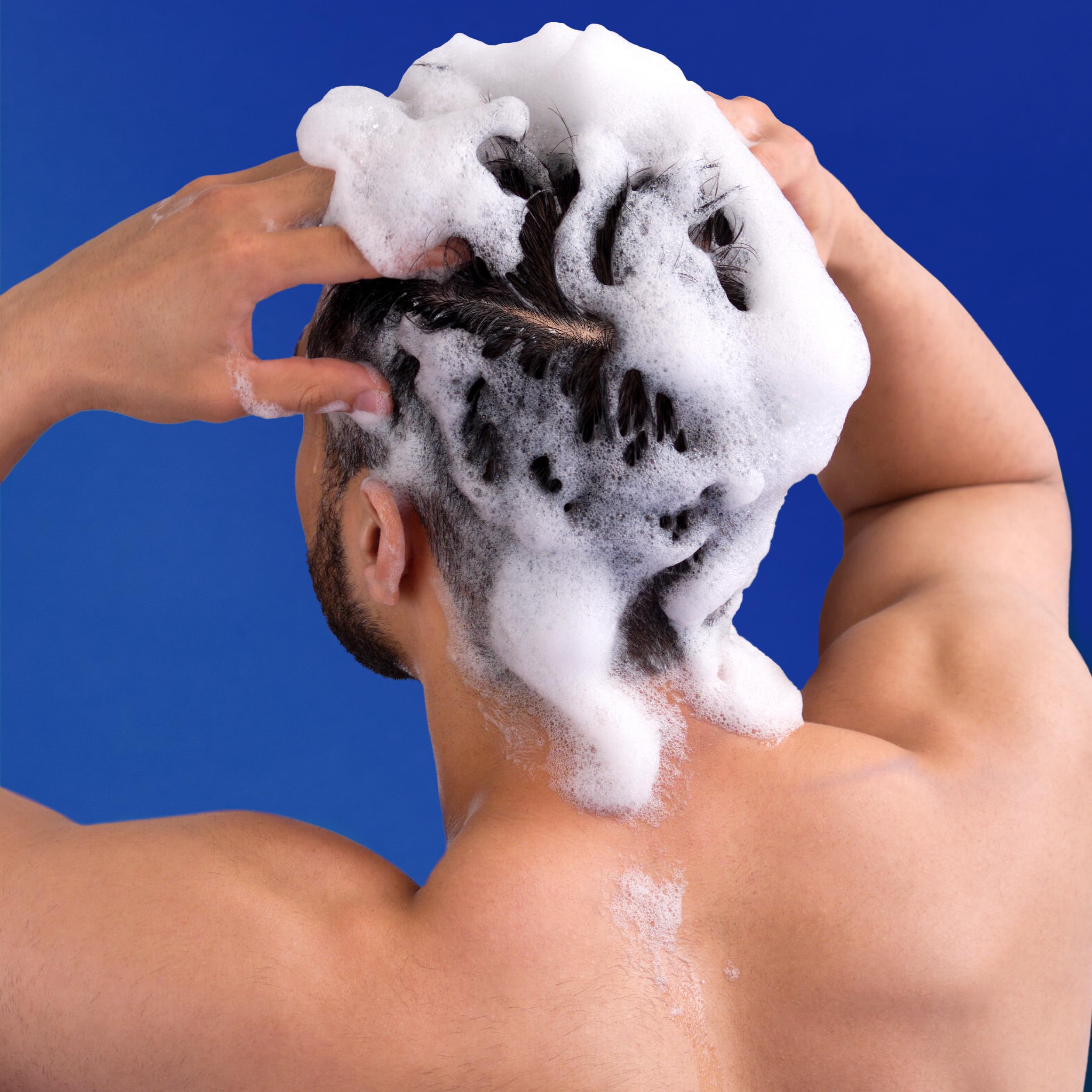 Head & Shoulders shampoo applied to scalp demonstrating flake removal benefit