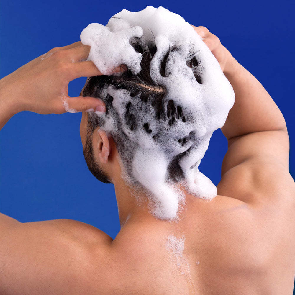 Head & Shoulders shampoo applied to scalp demonstrating flake removal benefit