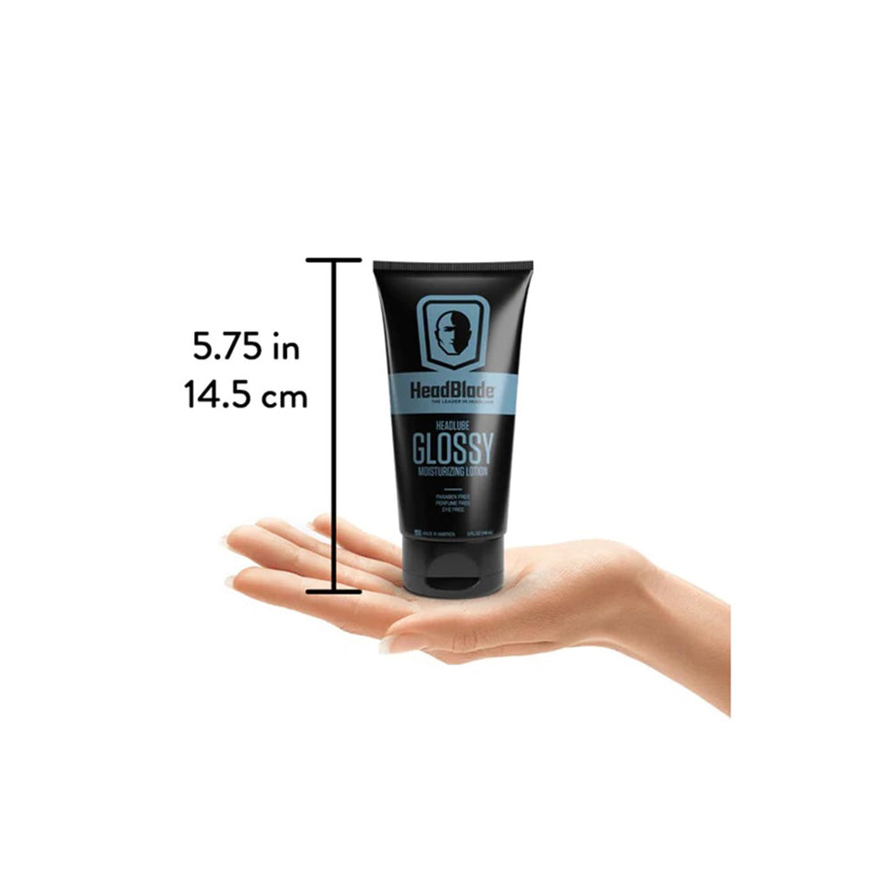 HeadBlade HeadLube 5 oz bottle next to coin for size comparison and travel-friendly benefit