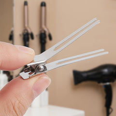 Hedume clip securing a pin curl to show reliable hold during styling
