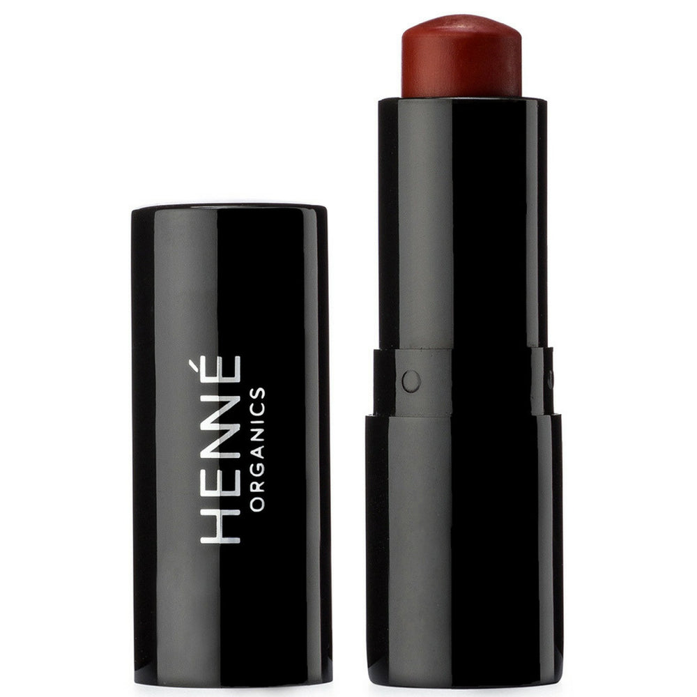 HennÃ Organics front packaging showing the luxe brick-red tube and label benefit: premium presentation