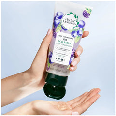 Herbal Essences tube in hand showing 6 oz size for travel-friendly styling