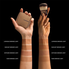 Hourglass bronzer lifestyle application with brush for natural sun‑kissed finish