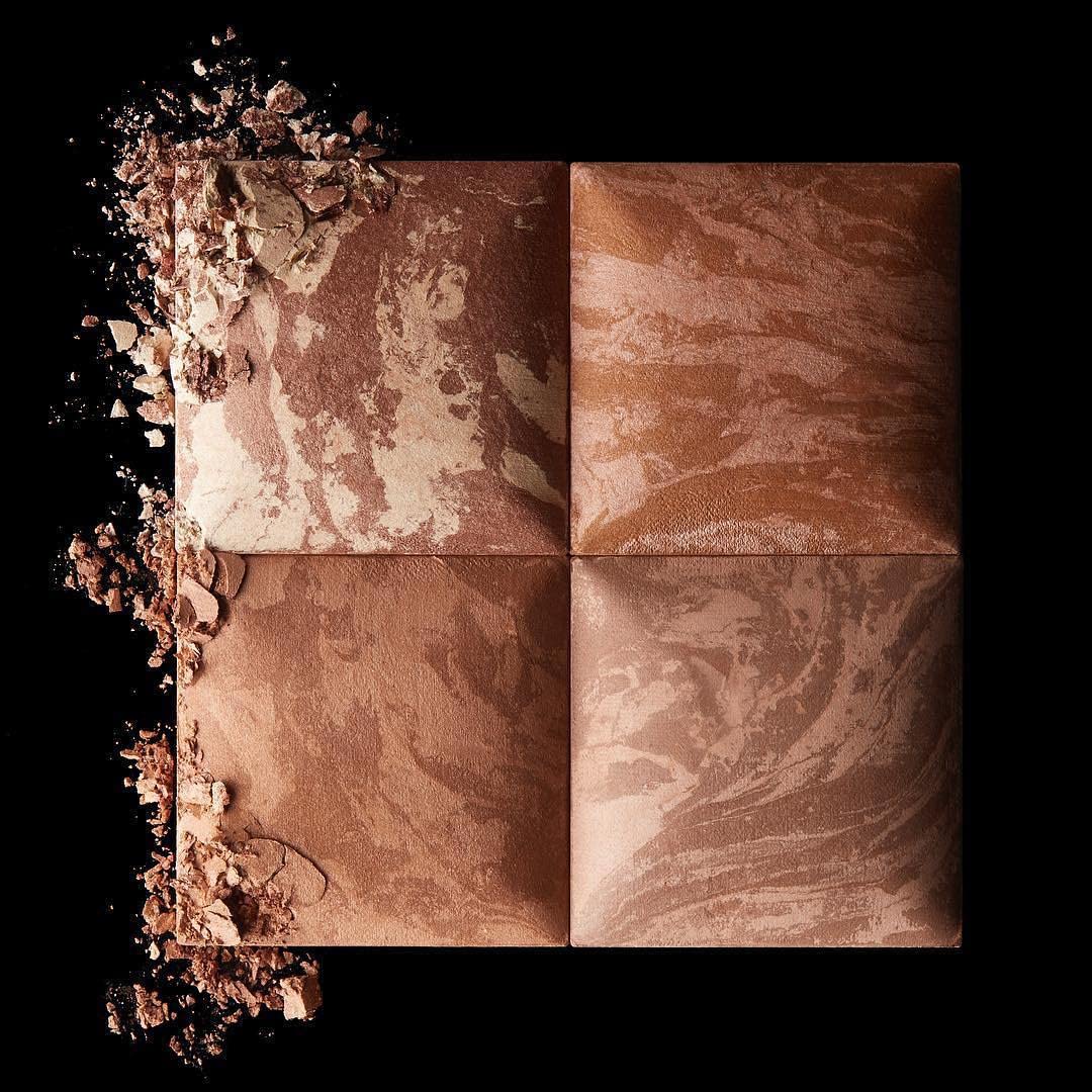 Hourglass bronzer swatch on skin demonstrating buildable warm tone and blendability