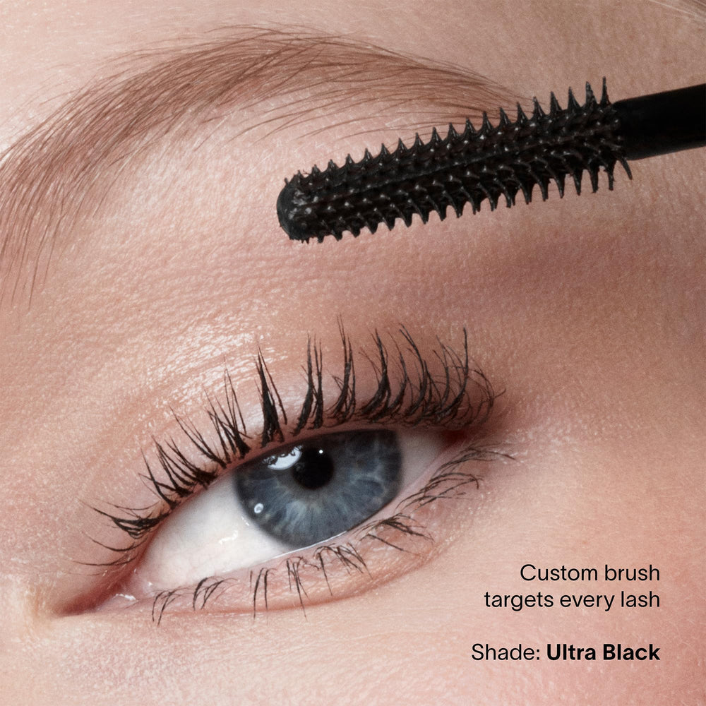 HOURGLASS mascara beside a coin to show compact size and travel-friendly convenience