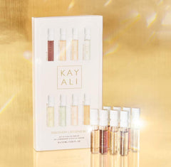 Huda KAYALI sampler vial close-up showing spray nozzle and label, easy testing benefit