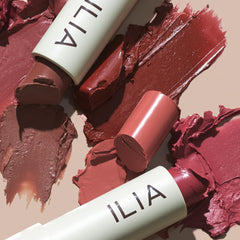 ILIA swatch of Heartbeats on wrist showcasing buildable warm-red color and natural finish