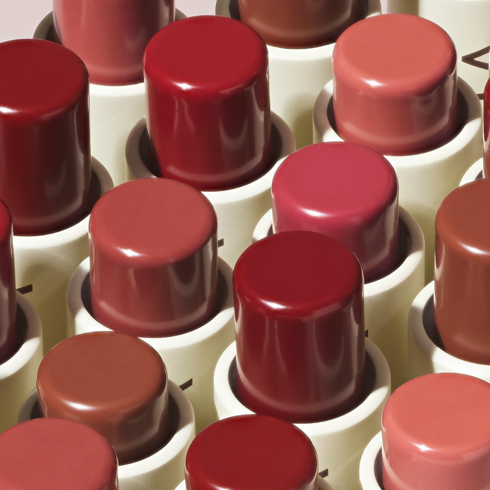 ILIA size comparison next to lipstick showing pocket-friendly convenience