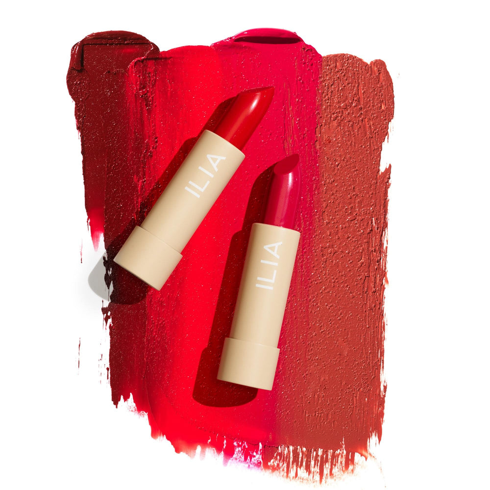 ILIA mood flatlay with lipstick and accessories suggesting everyday polished look
