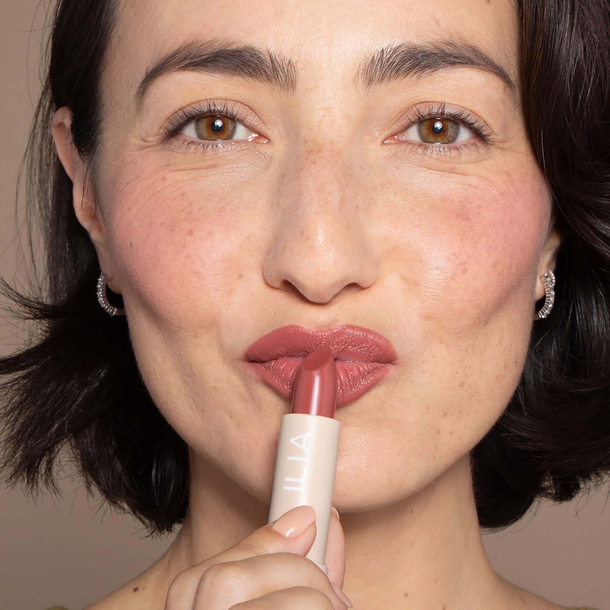 ILIA model wearing Marsala with a natural smile for wearable color benefit