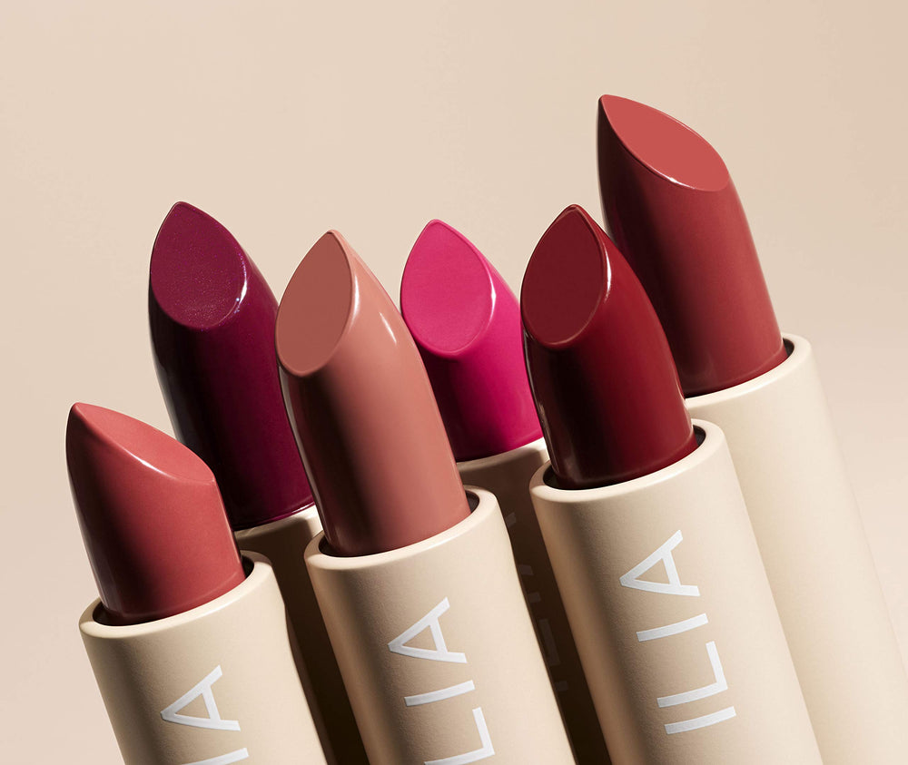 ILIA Tango next to a standard lipstick for scale demonstrating compact size