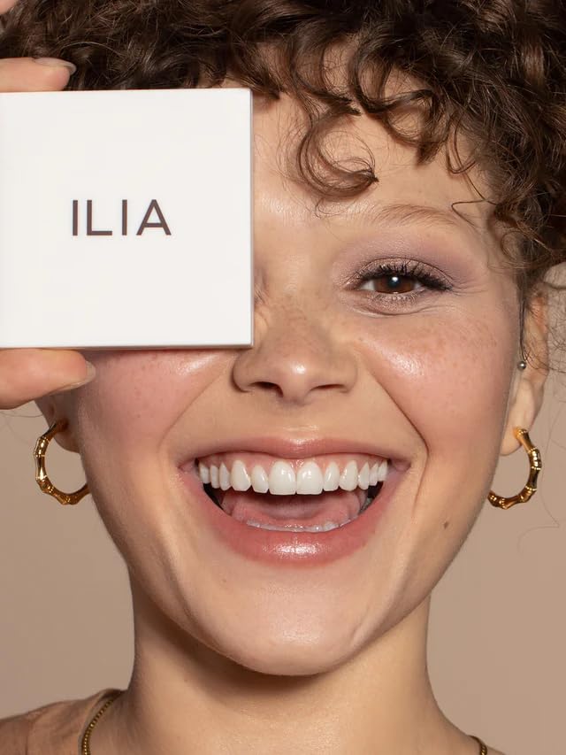 ILIA compact held in hand to show true size and travel-friendly benefit