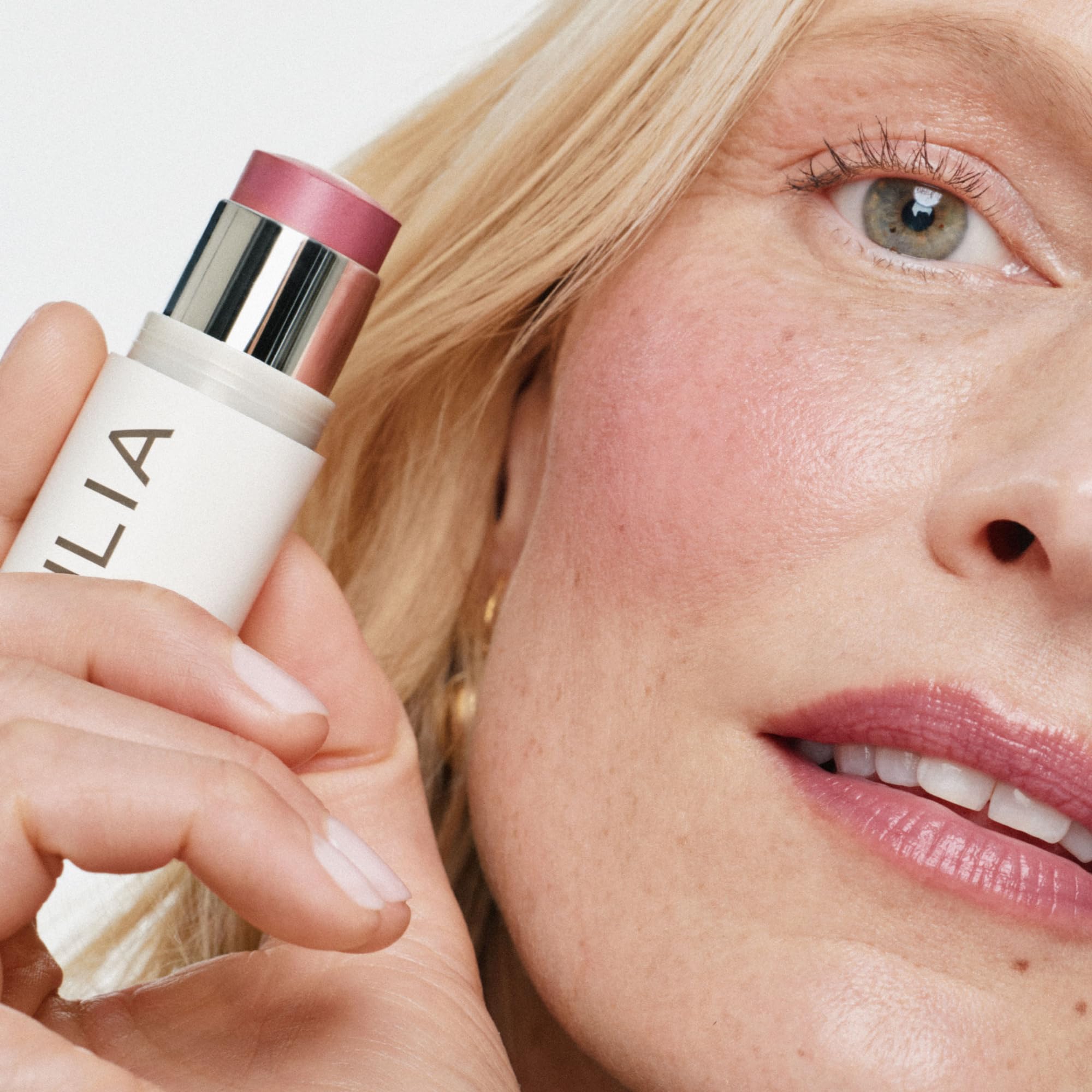 ILIA stick applied to cheek showing natural flush and easy blending benefit