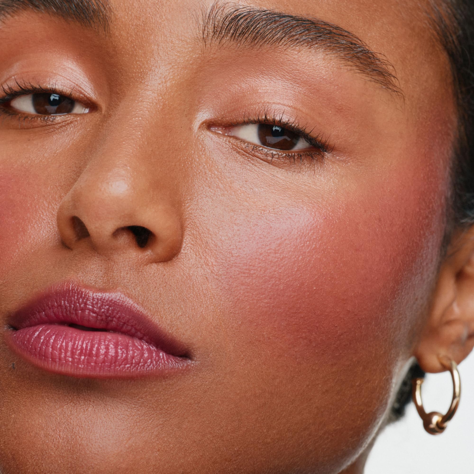 ILIA multi-stick applied on cheek blended for easy, buildable color