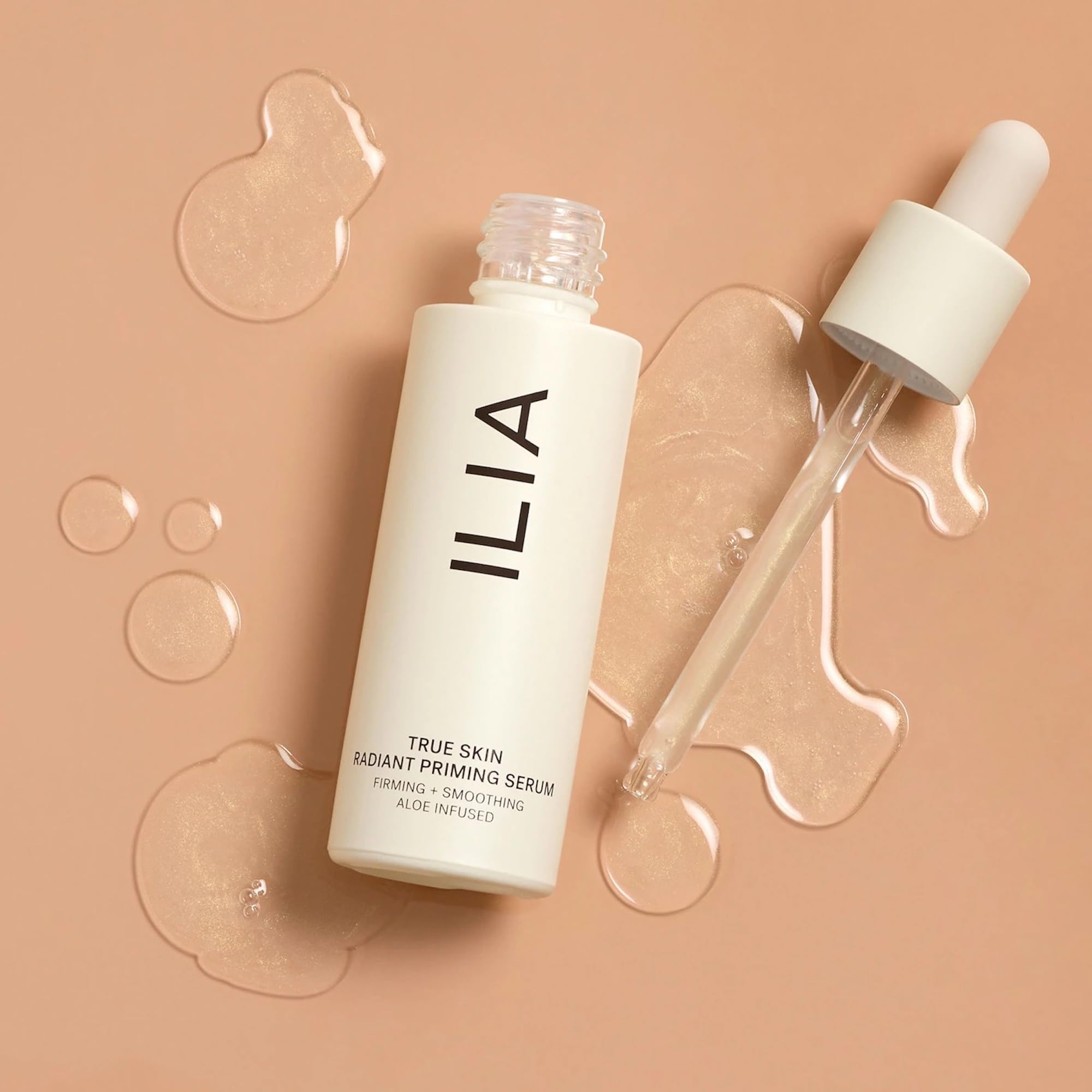 ILIA 30ml bottle next to credit card showing compact travel-friendly benefit