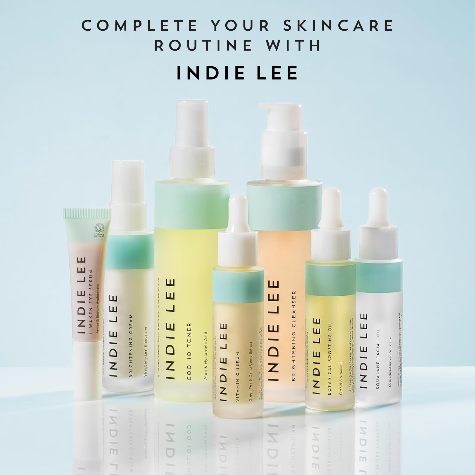 Indie Lee 125ml bottle beside common items to show travel-friendly size