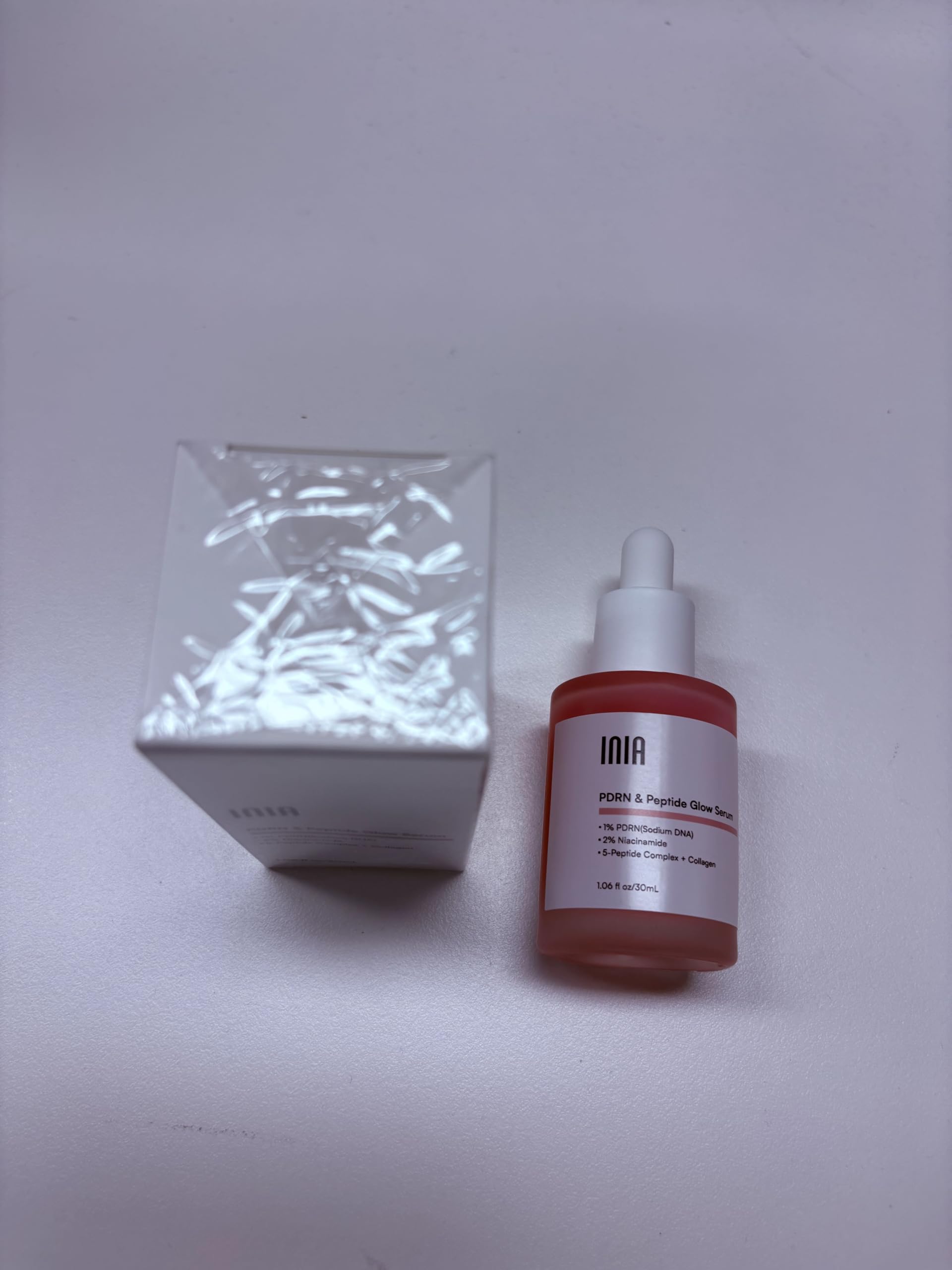 INIA ingredients flatlay featuring PDRN, niacinamide and botanicals