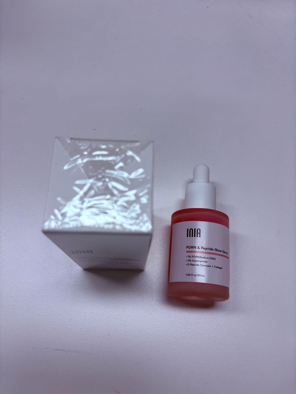 INIA ingredients flatlay featuring PDRN, niacinamide and botanicals