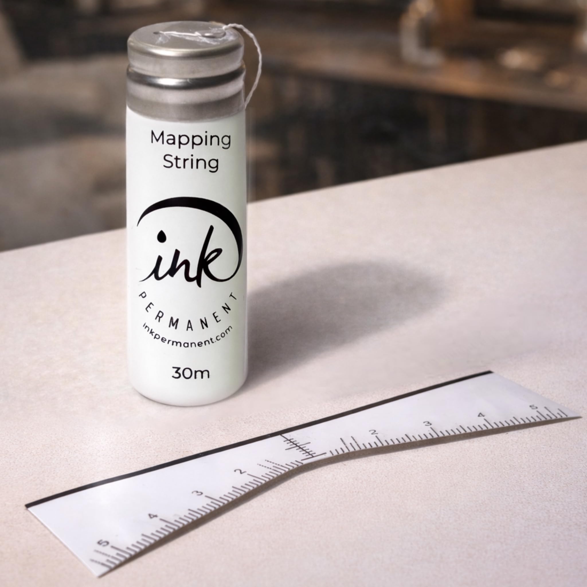 Ink Permanent pre-inked string close-up showing clear guide line benefit