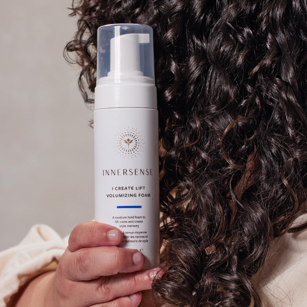 Innersense I Create Lift held in hand for scale to show compact 2.37oz travel-friendly size
