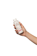 IRALTONE bottle in hand for size comparison showing 200ml portability benefit