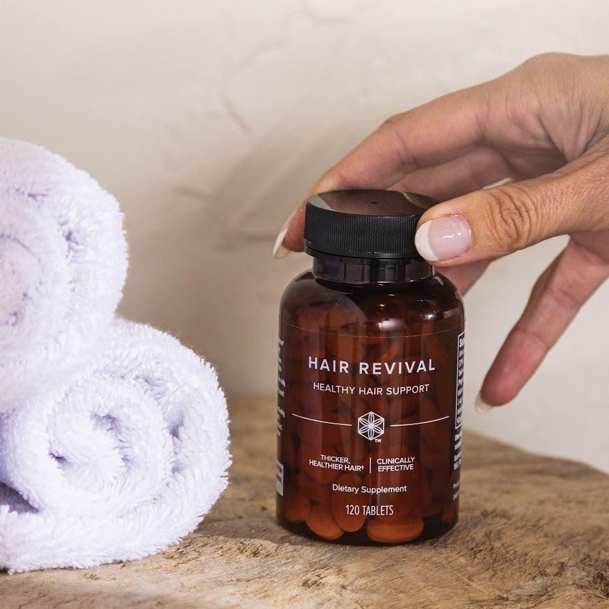 Isagenix bottle beside scalp massage tool showing complement to scalp care benefits