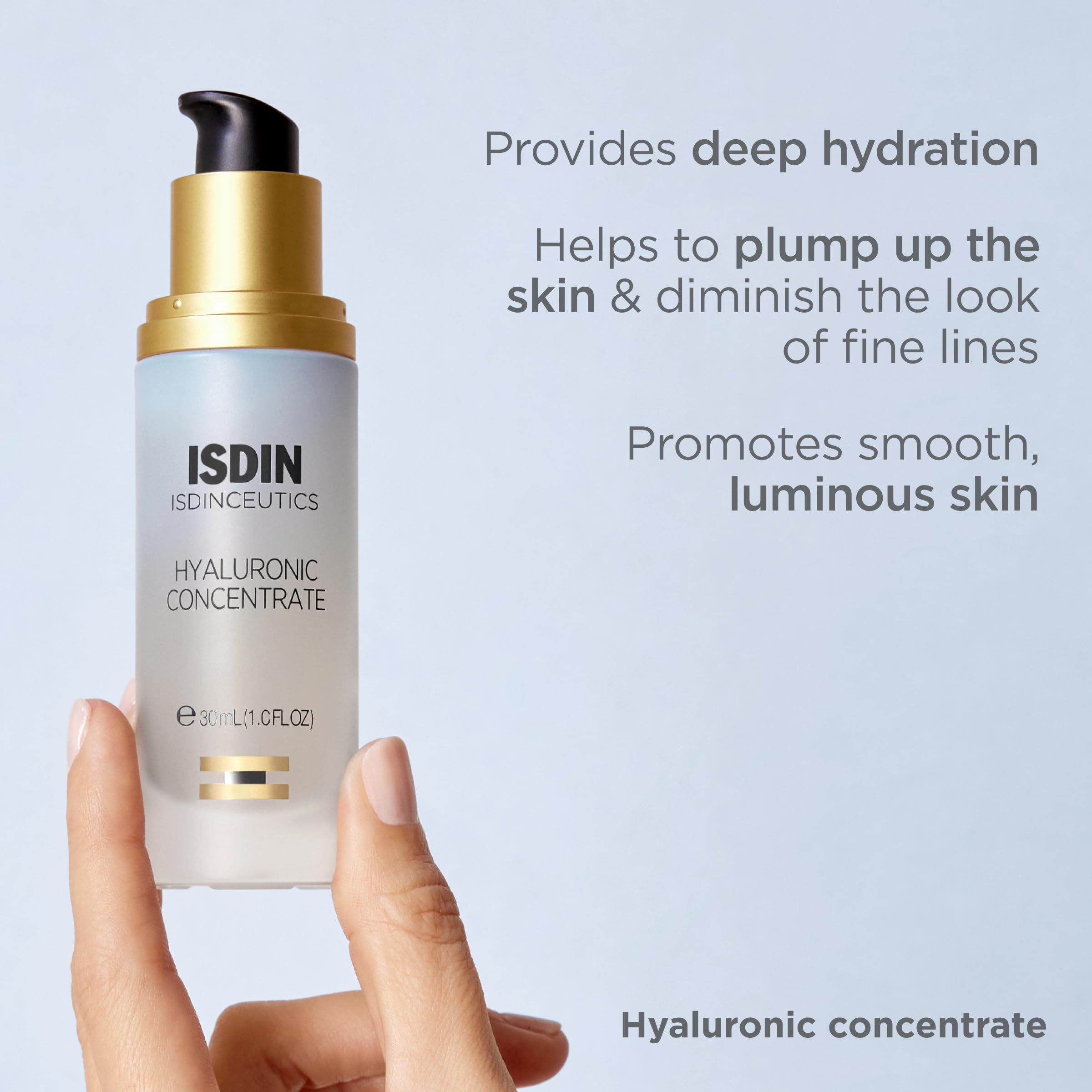 Hand holding ISDIN 1 fl oz travel bottle showing portability benefit