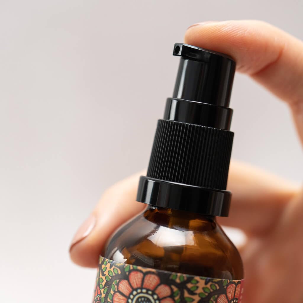 The Ayurveda Experience bottle in hand scale comparison for size and travel convenience