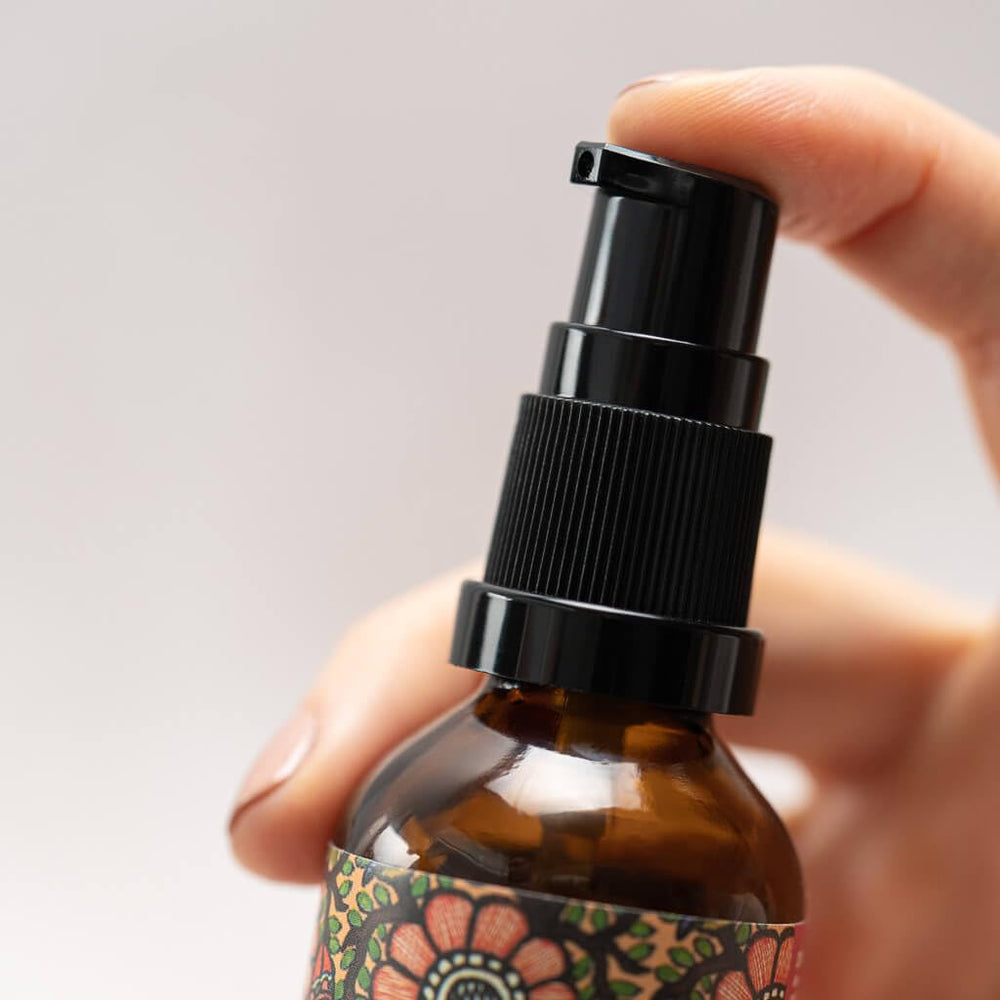 The Ayurveda Experience bottle in hand scale comparison for size and travel convenience
