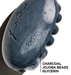 Jack Black charcoal body bar detailed shot of jojoba bead texture revealing gentle exfoliating particles for smoother skin