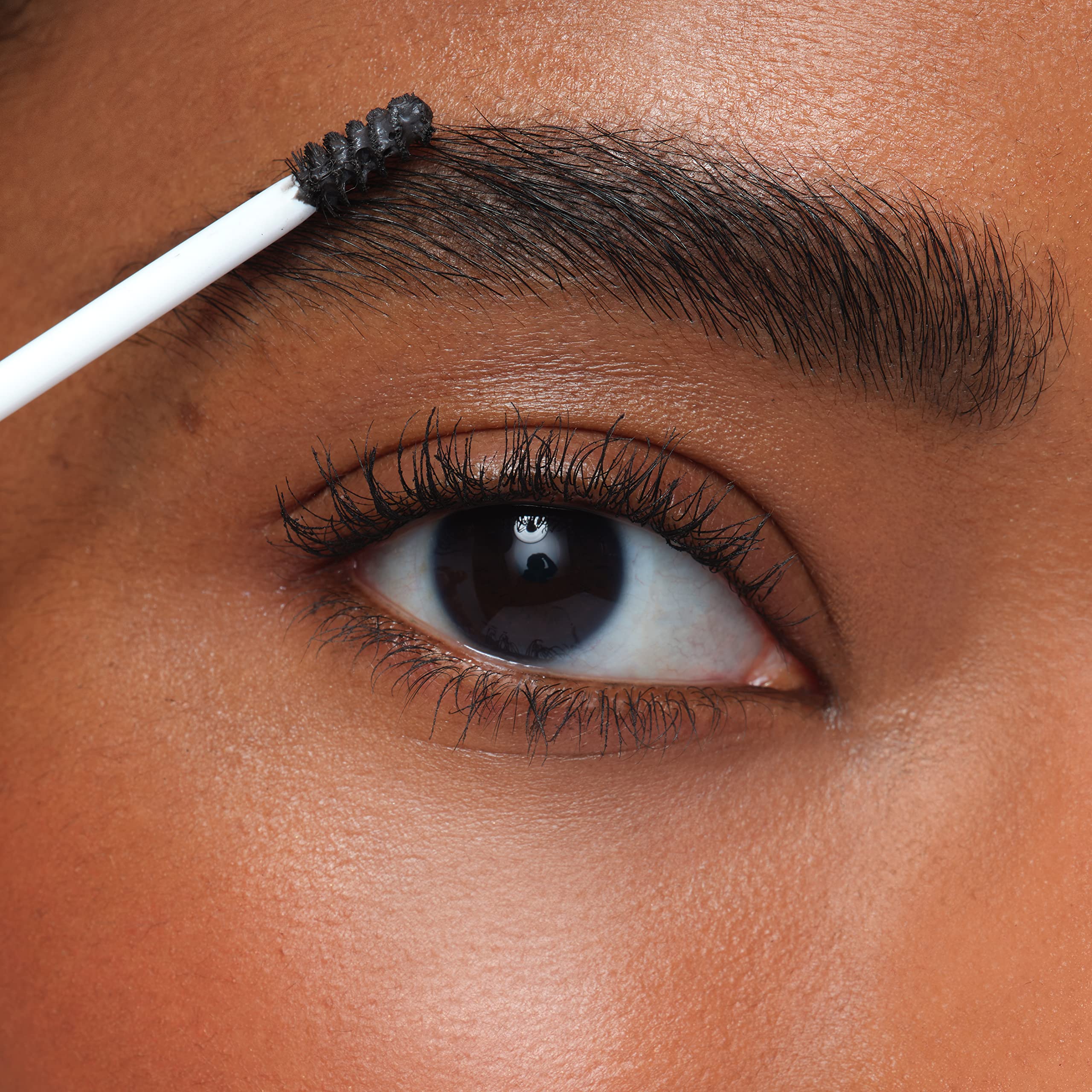 jane iredale PureBrow next to common objects for size comparison and travel convenience