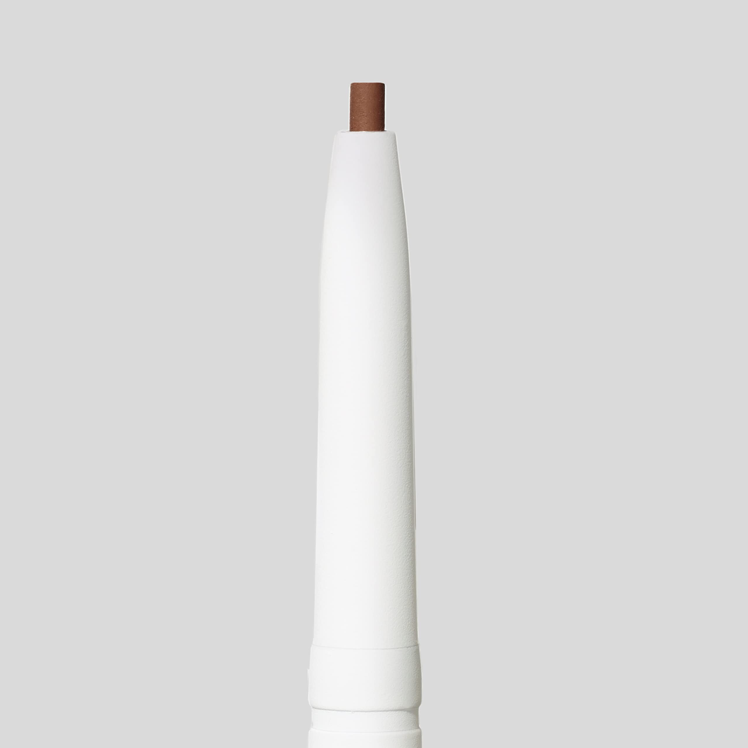 hand holding jane iredale pencil for scale and easy on-the-go brow touch-ups