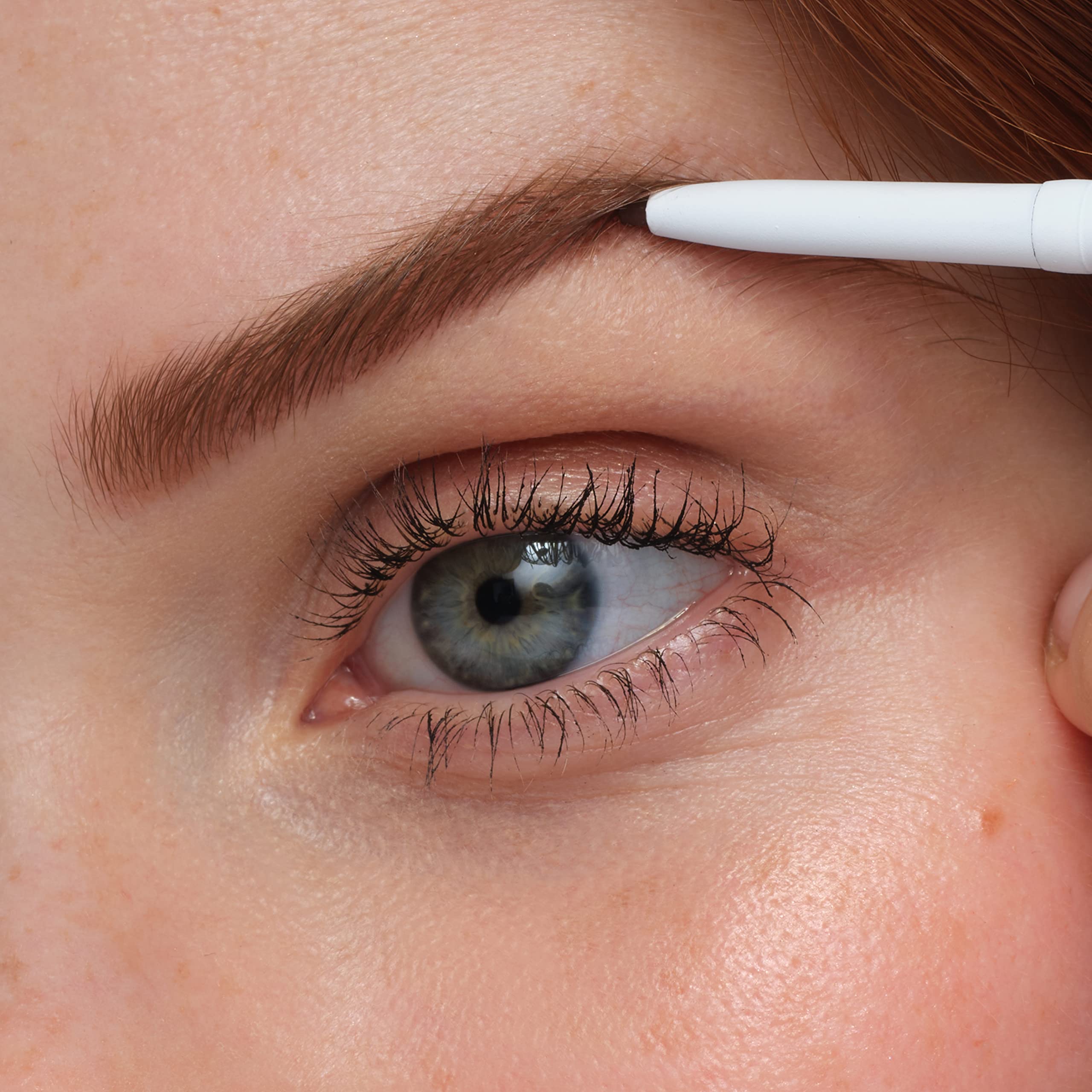 model applying jane iredale pencil to brows for natural definition and shape
