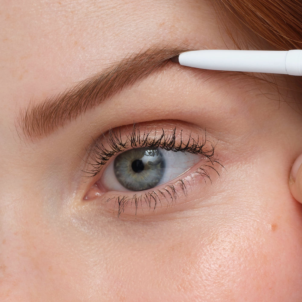 model applying jane iredale pencil to brows for natural definition and shape