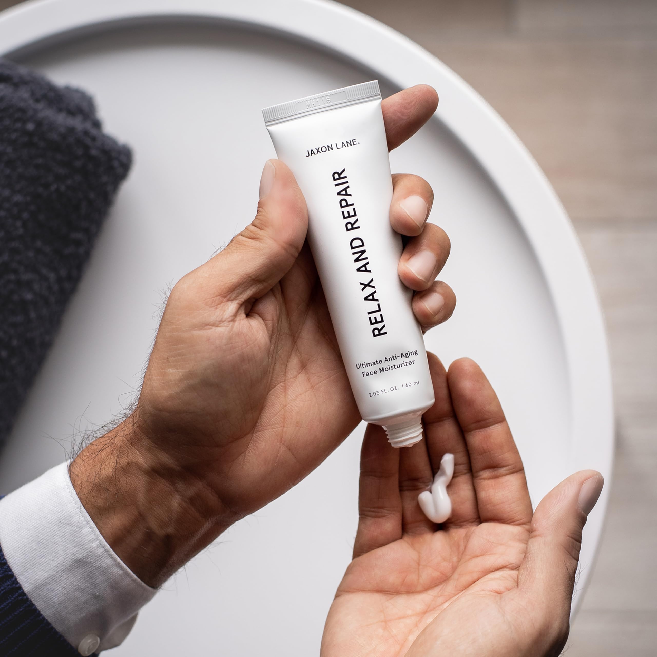 JAXON LANE man applying cream demonstrating smooth application and comfort