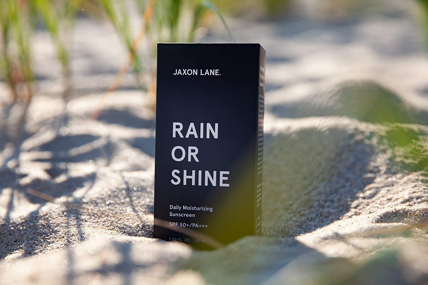 JAXON LANE travel tube beside passport showing TSA-friendly convenience