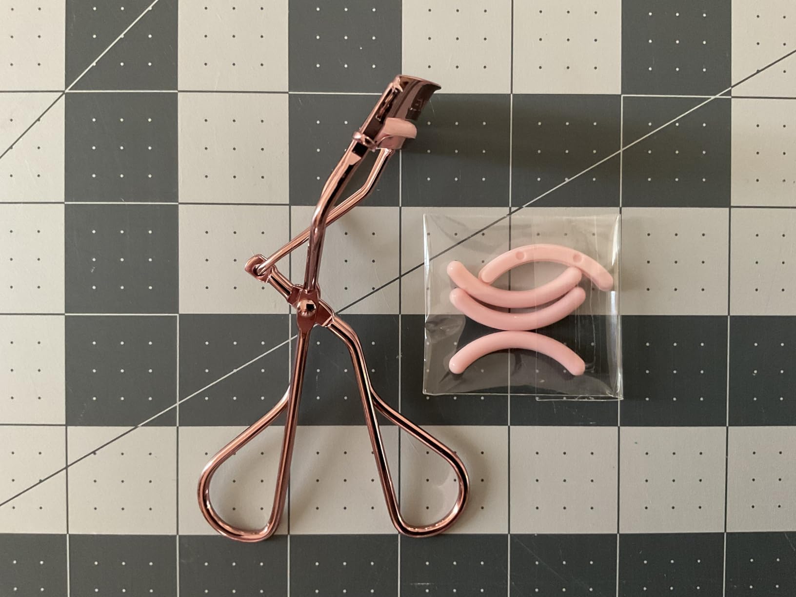 Jenny Patinkin replacement silicone pad beside curler for long-lasting use