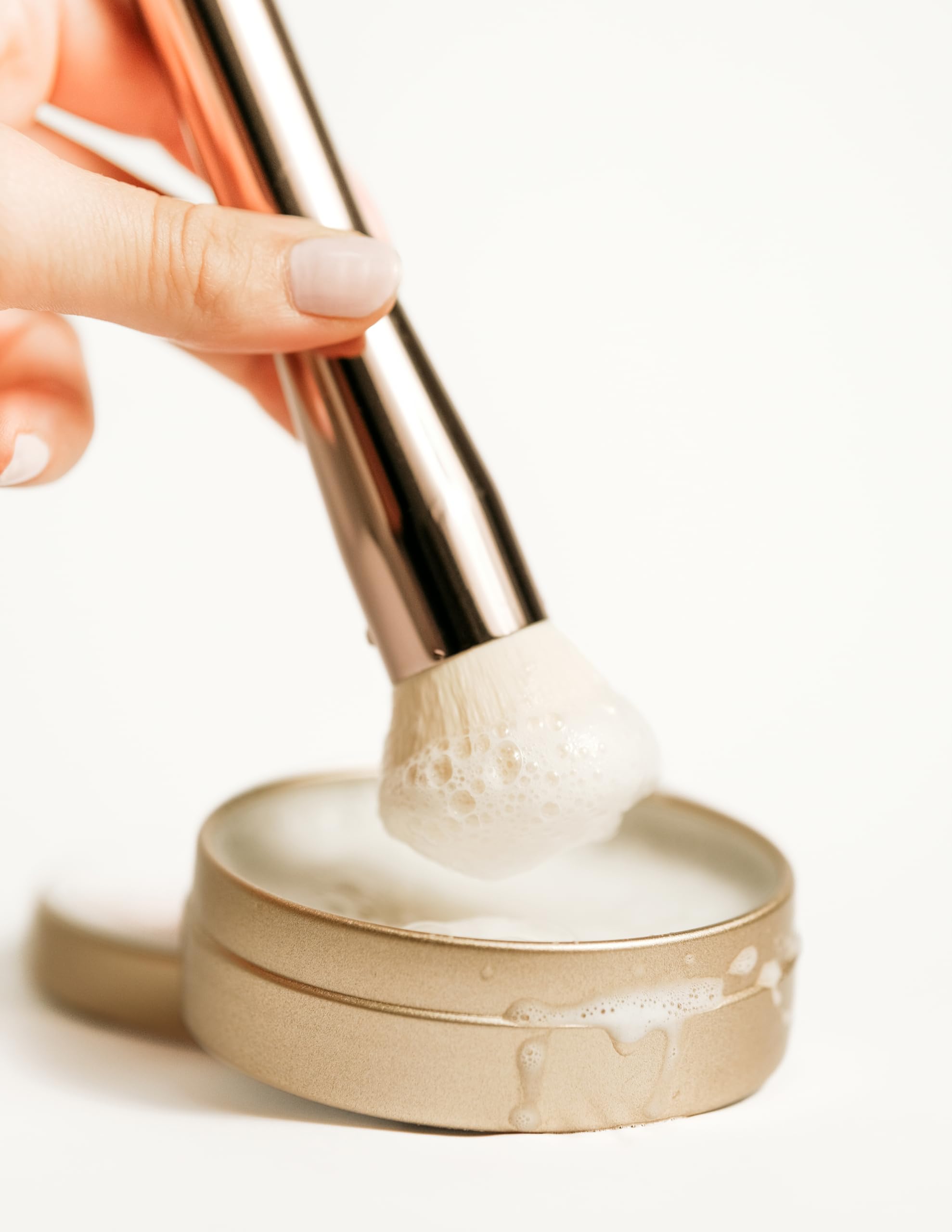 Jenny Patinkin size in hand demonstrating compact 2.6 oz travel-friendly jar