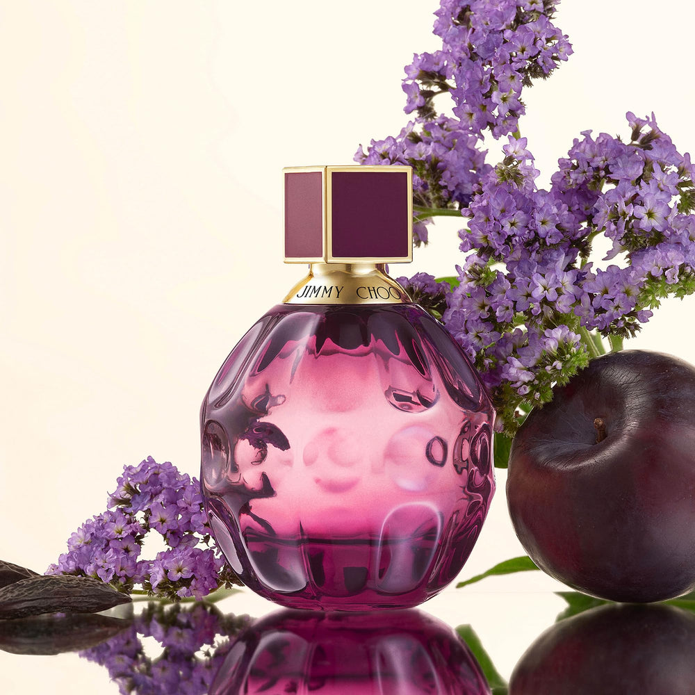 Hand holding JIMMY CHOO Fever travel spray to show size and easy carrying benefit