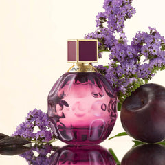 Hand holding JIMMY CHOO Fever travel spray to show size and easy carrying benefit