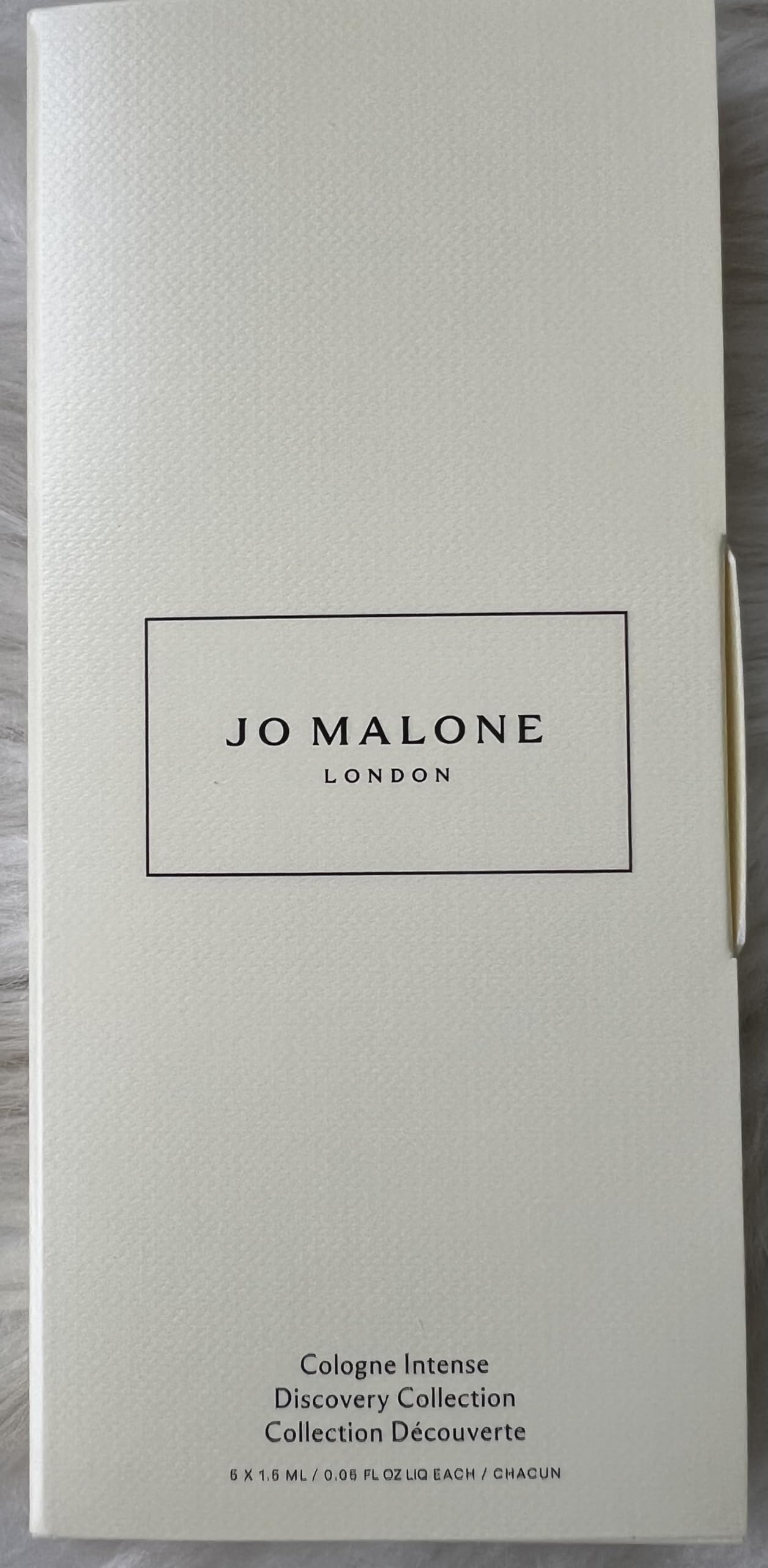 Mini vials of Jo Malone Cologne Intense inside a travel pouch illustrating portability and everyday use
