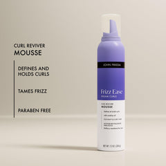 John Frieda applying mousse to damp curls for enhanced curl definition