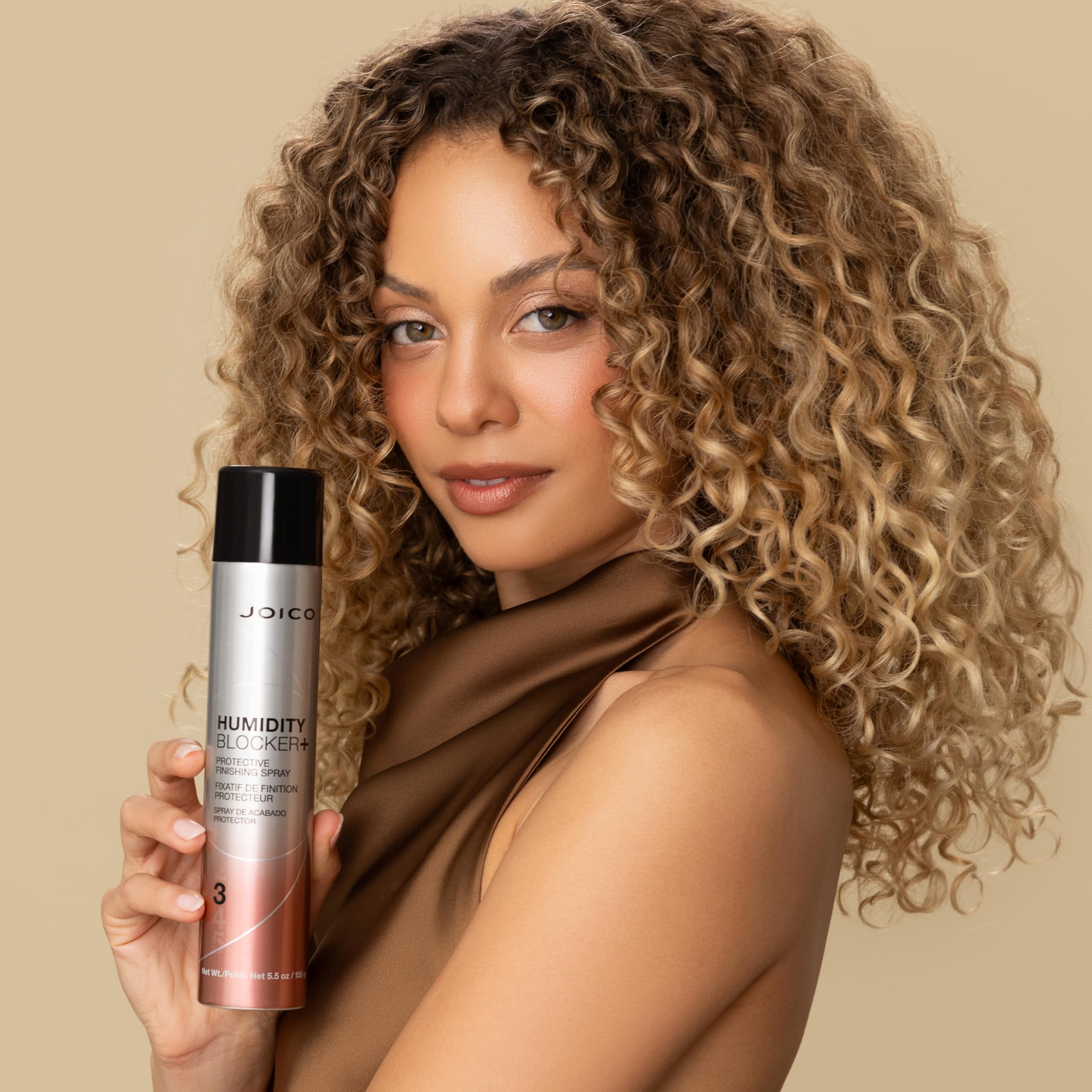 Joico bottle held in hand demonstrating 5.5 fl oz travel-friendly size