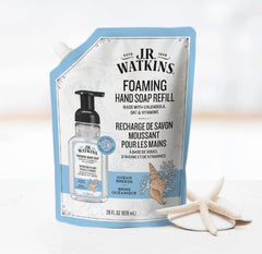 J.R. Watkins pouring refill into foaming bottle for easy use benefit