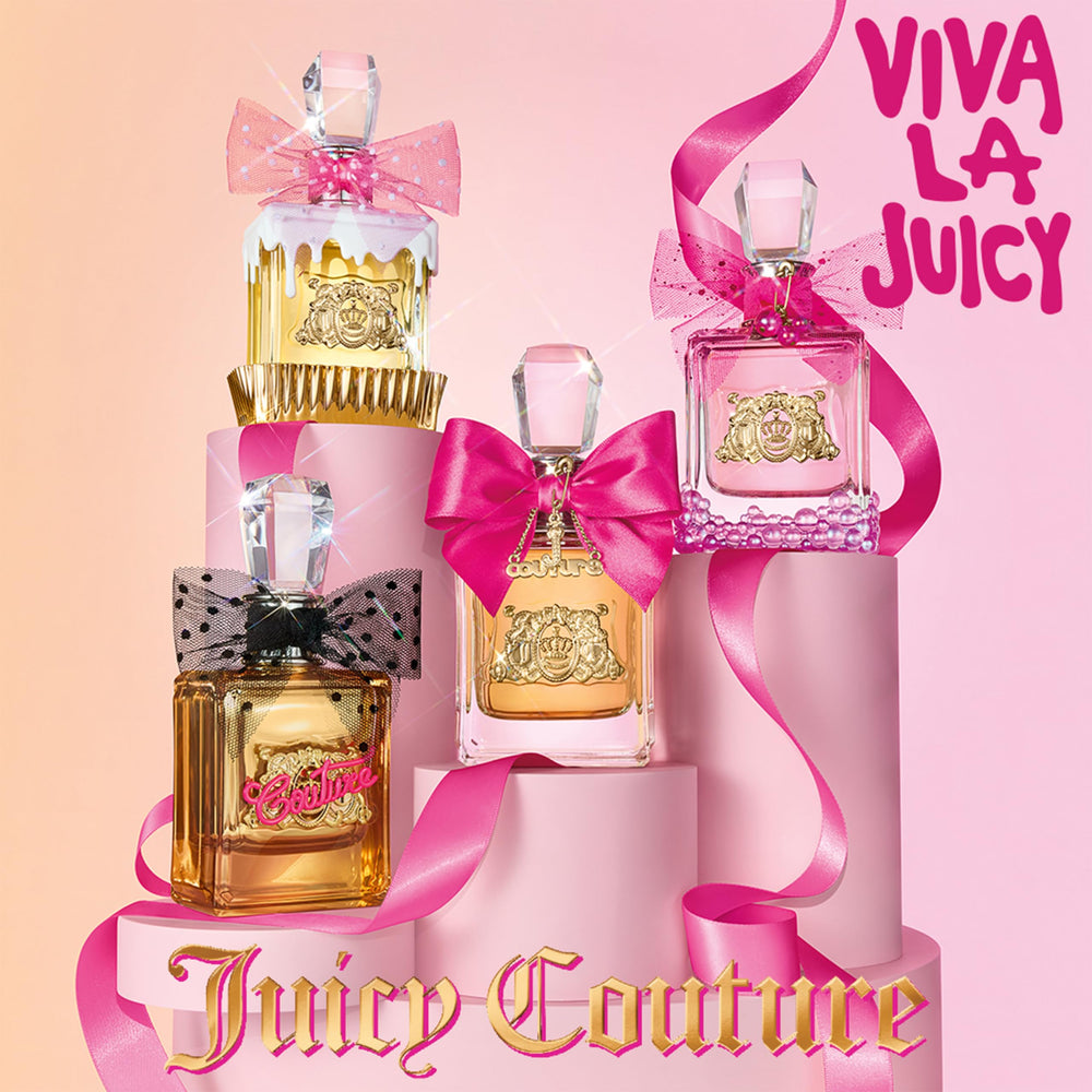 Juicy Couture Viva La Juicy next to a ruler to show the 3.4 fl oz size for scale comparison